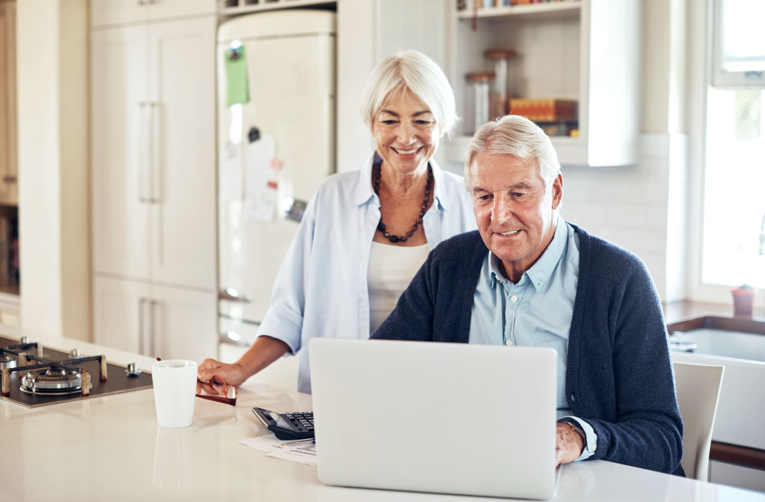older couple looking at life insurance policies on a laptop